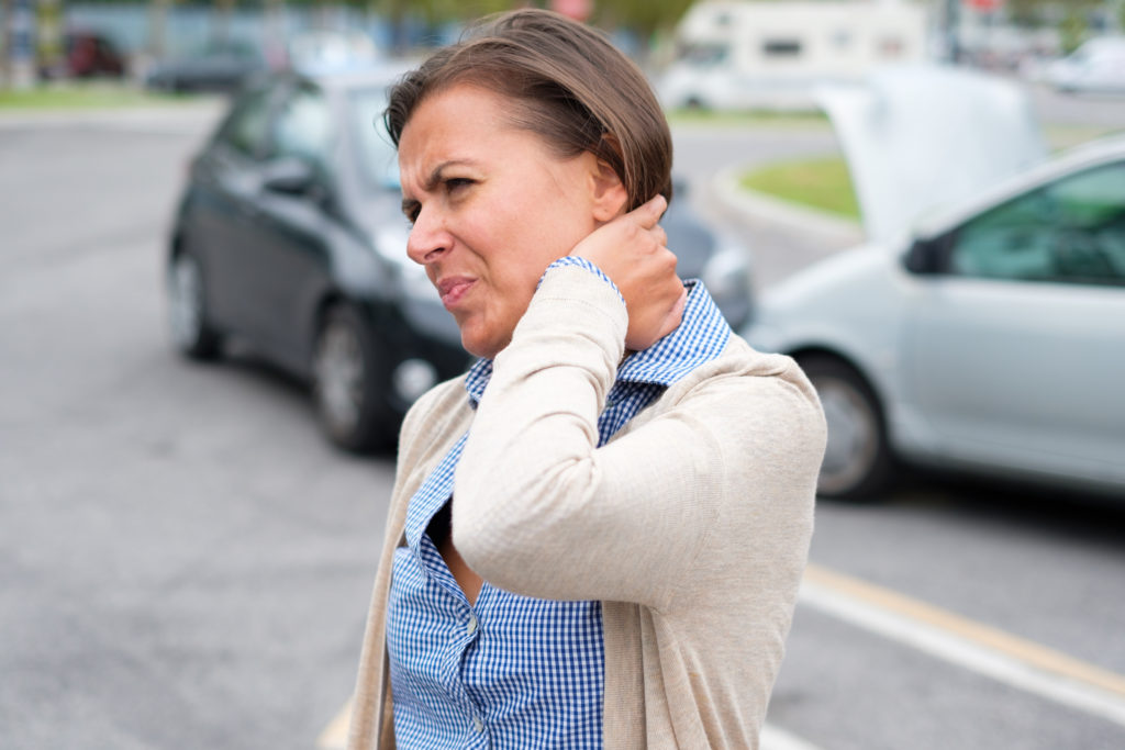 A women expressing pain after suffering an injury during an auto accident in Philadelphia